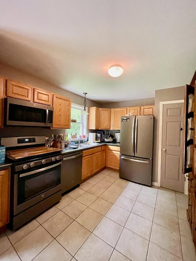 496 Minisink Tpke, Port Jervis, NY 12771 - kitchen with stainless steel appliances, a sink, light tile patterned floors, hanging light fixtures, and dark countertops