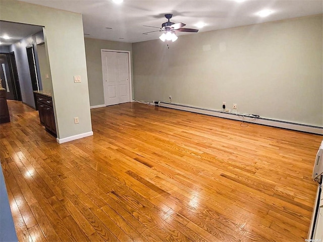 22820 Edgewood Ave, Laurelton, NY 11413 - unfurnished room featuring hardwood / wood-style floors, a baseboard heating unit, a ceiling fan, and baseboards
