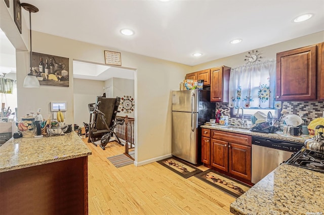 22820 Edgewood Ave, Laurelton, NY 11413 - kitchen with appliances with stainless steel finishes, a sink, light wood-style flooring, decorative backsplash, and recessed lighting