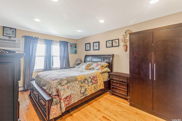22820 Edgewood Ave, Laurelton, NY 11413 - bedroom featuring light wood-style floors, an AC wall unit, and recessed lighting