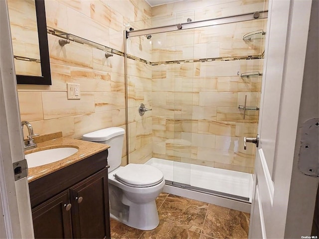 22820 Edgewood Ave, Laurelton, NY 11413 - full bathroom with toilet, a stall shower, vanity, and tile walls