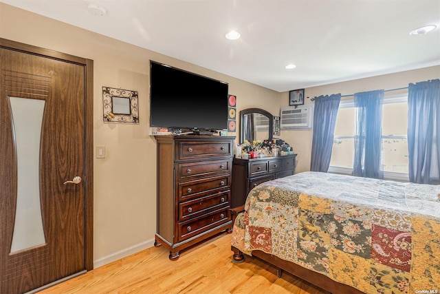 22820 Edgewood Ave, Laurelton, NY 11413 - bedroom featuring light wood-style floors, a wall mounted air conditioner, baseboards, and recessed lighting