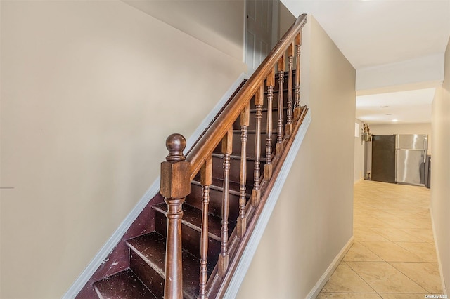 22820 Edgewood Ave, Laurelton, NY 11413 - staircase featuring baseboards and tile patterned floors