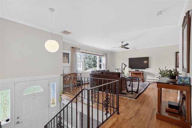 15 Richard Rd, Mahopac, NY 10541 - entryway with ornamental molding, wood finished floors, a ceiling fan, and a baseboard radiator