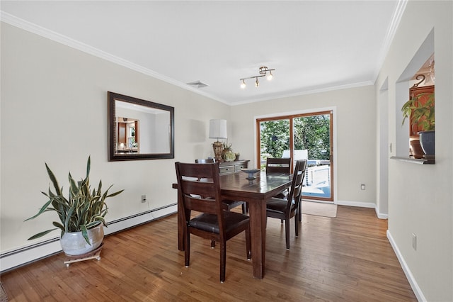 15 Richard Rd, Mahopac, NY 10541 - dining space with a baseboard heating unit, wood finished floors, crown molding, a baseboard radiator, and rail lighting