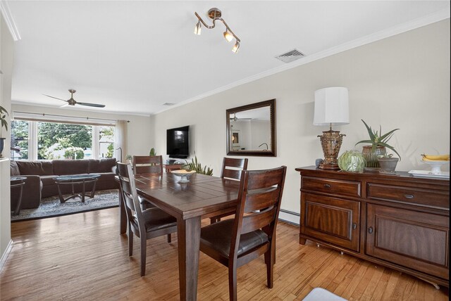 15 Richard Rd, Mahopac, NY 10541 - dining room featuring a baseboard heating unit, light wood-style flooring, ceiling fan, and crown molding