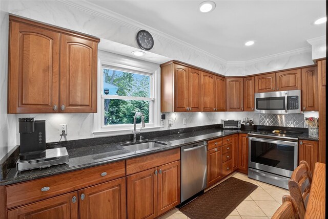 15 Richard Rd, Mahopac, NY 10541 - kitchen with appliances with stainless steel finishes, dark stone counters, brown cabinets, crown molding, and recessed lighting