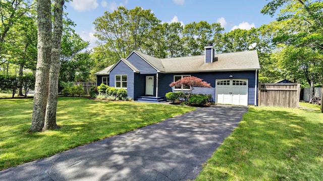 4 Bay View Dr W, Hampton Bays, NY 11946 - view of front facade with an attached garage, a chimney, and driveway