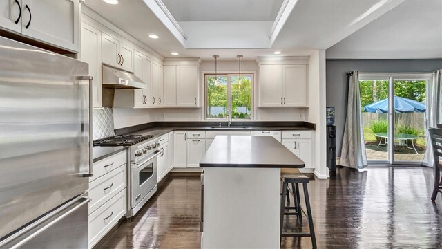 4 Bay View Dr W, Hampton Bays, NY 11946 - kitchen with premium appliances, under cabinet range hood, a sink, plenty of natural light, and recessed lighting