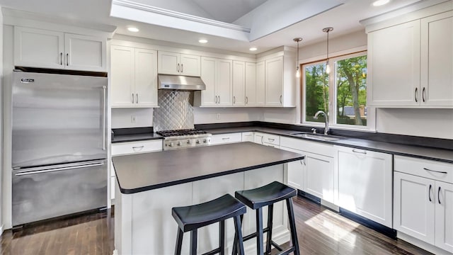 4 Bay View Dr W, Hampton Bays, NY 11946 - kitchen featuring stainless steel appliances, a sink, under cabinet range hood, dark countertops, and recessed lighting