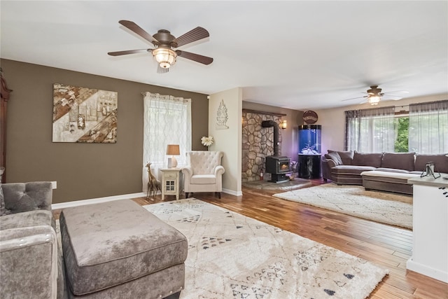 316 Myers Corners Rd, Wappingers Falls, NY 12590 - living area with ceiling fan, a wood stove, wood finished floors, and baseboards