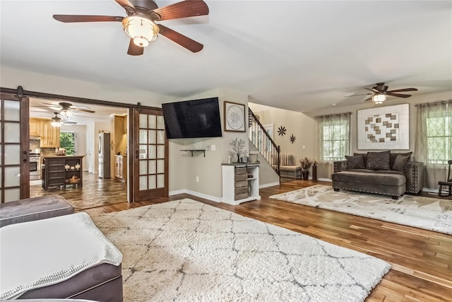 316 Myers Corners Rd, Wappingers Falls, NY 12590 - living room featuring a barn door, stairway, and a ceiling fan