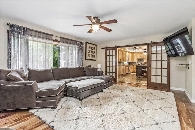316 Myers Corners Rd, Wappingers Falls, NY 12590 - living room featuring a ceiling fan, wood finished floors, baseboards, and a barn door