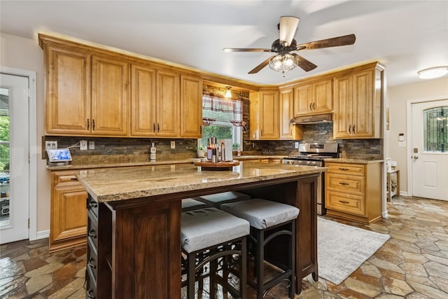 316 Myers Corners Rd, Wappingers Falls, NY 12590 - kitchen featuring stainless steel gas range, dark stone finish floors, tasteful backsplash, and a center island