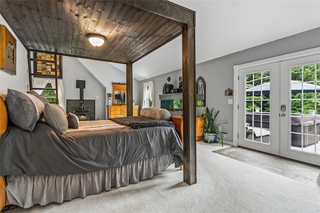 316 Myers Corners Rd, Wappingers Falls, NY 12590 - carpeted bedroom featuring access to exterior, vaulted ceiling, a wood stove, and french doors