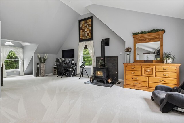 316 Myers Corners Rd, Wappingers Falls, NY 12590 - bedroom featuring lofted ceiling, multiple windows, a wood stove, and carpet flooring