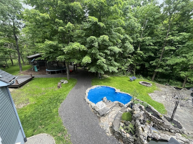316 Myers Corners Rd, Wappingers Falls, NY 12590 - swimming pool featuring a trampoline, an outdoor fire pit, and a yard