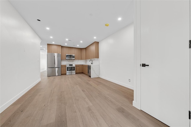 312 Fenimore St, Brooklyn, NY 11225 - kitchen featuring appliances with stainless steel finishes, recessed lighting, light countertops, backsplash, and light wood-style floors