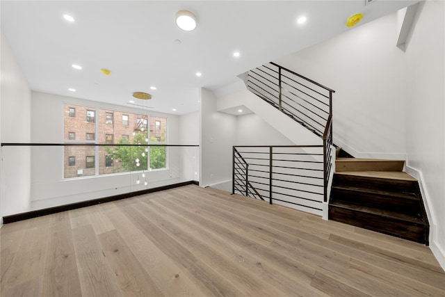 312 Fenimore St, Brooklyn, NY 11225 - unfurnished living room with wood finished floors, recessed lighting, baseboards, and stairs