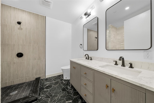 312 Fenimore St, Brooklyn, NY 11225 - full bath with tiled shower, toilet, double vanity, marble look tiles, and baseboards