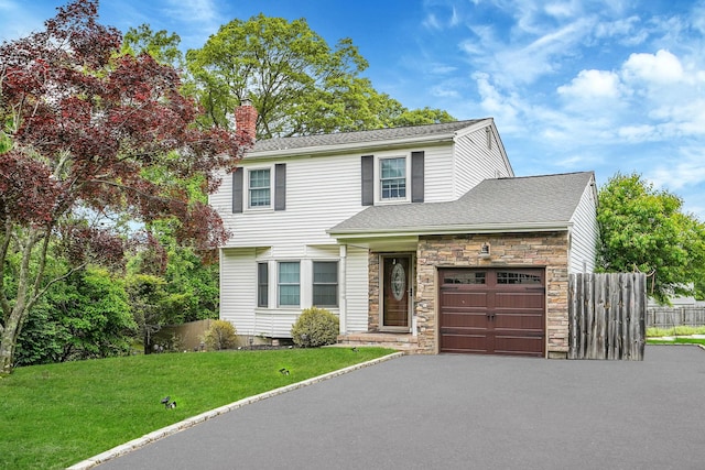 7 Daniel Ct, Lake Ronkonkoma, NY 11779 - traditional-style house featuring an attached garage, stone siding, driveway, a chimney, and roof with shingles