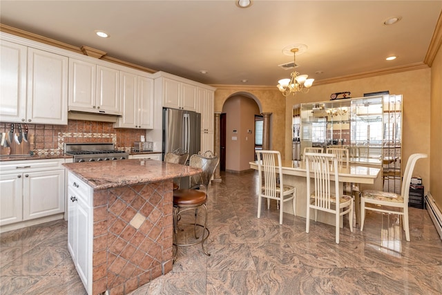1338 Kearney Ave, Bronx, NY 10465 - kitchen with freestanding refrigerator, range, a chandelier, arched walkways, and ornamental molding