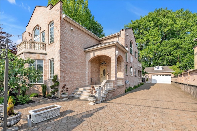 1338 Kearney Ave, Bronx, NY 10465 - view of front of house featuring brick siding, an outbuilding, a detached garage, and a balcony