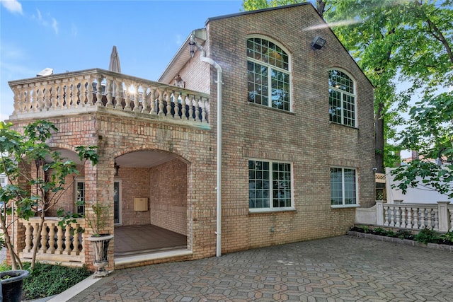 1338 Kearney Ave, Bronx, NY 10465 - view of side of property with brick siding, a patio area, and a balcony