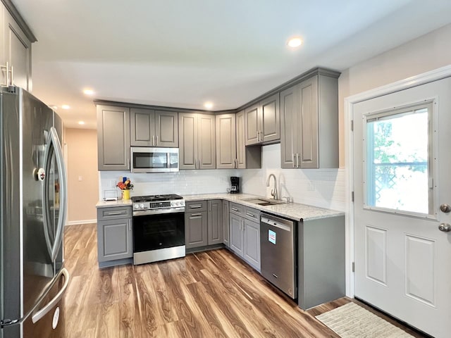 7 Mindy Ln, Jericho, NY 11590 - kitchen featuring gray cabinetry, stainless steel appliances, light wood-style floors, decorative backsplash, and recessed lighting