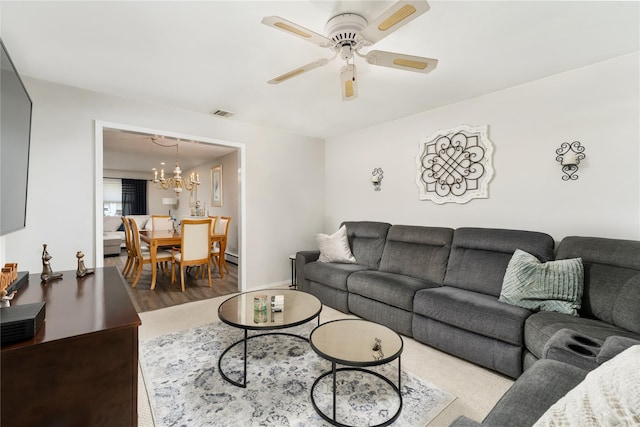 14FELWAYDRIVE Felway Dr Unit 14, Coram, NY 11727 - living area featuring a chandelier, wood finished floors, ceiling fan, and a baseboard heating unit