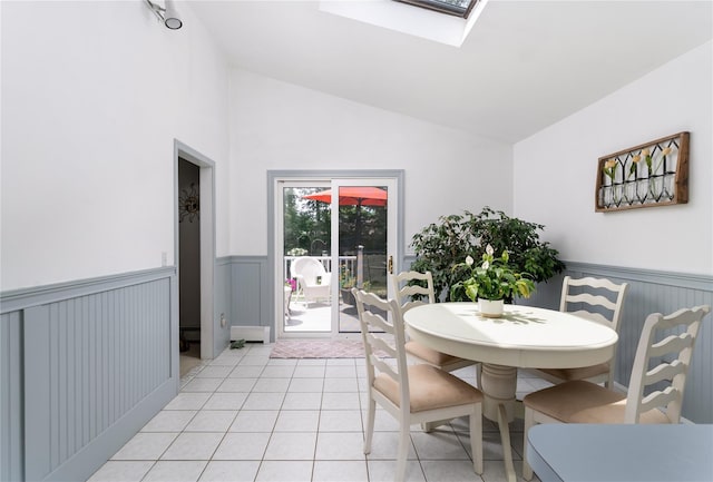 14FELWAYDRIVE Felway Dr Unit 14, Coram, NY 11727 - dining space featuring a wainscoted wall, light tile patterned flooring, a skylight, and high vaulted ceiling