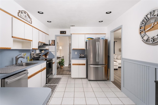 14FELWAYDRIVE Felway Dr Unit 14, Coram, NY 11727 - kitchen with appliances with stainless steel finishes, a sink, under cabinet range hood, white cabinets, and light tile patterned floors