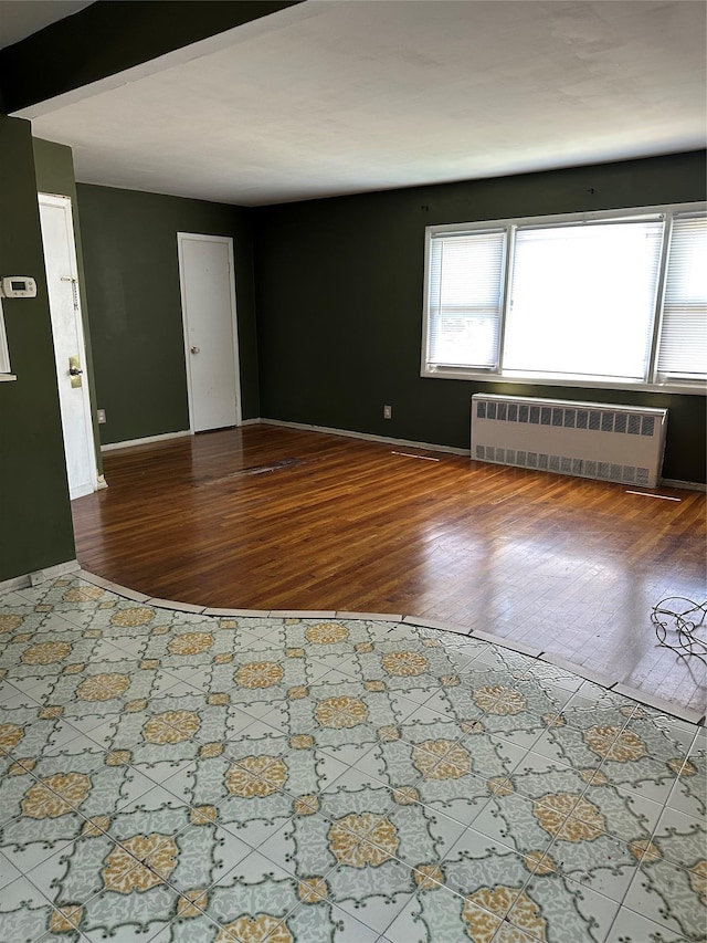 50 Mahland Pl, Oceanside, NY 11572 - spare room with radiator heating unit, wood finished floors, and baseboards
