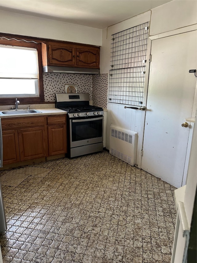 50 Mahland Pl, Oceanside, NY 11572 - kitchen featuring stainless steel gas range oven, radiator heating unit, a sink, light countertops, and tasteful backsplash