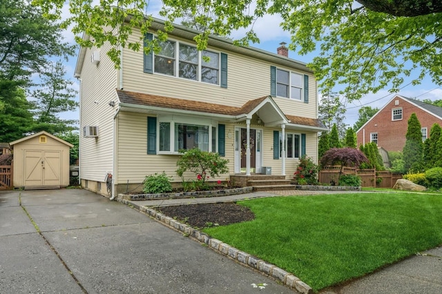 74 Miles Ave, Albertson, NY 11507 - traditional-style home featuring a chimney, a front yard, a storage unit, and concrete driveway