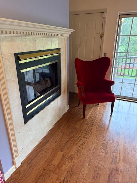 1010 Washington Grn Unit 1010, New Windsor, NY 1255312553 - living area featuring wood finished floors and a fireplace