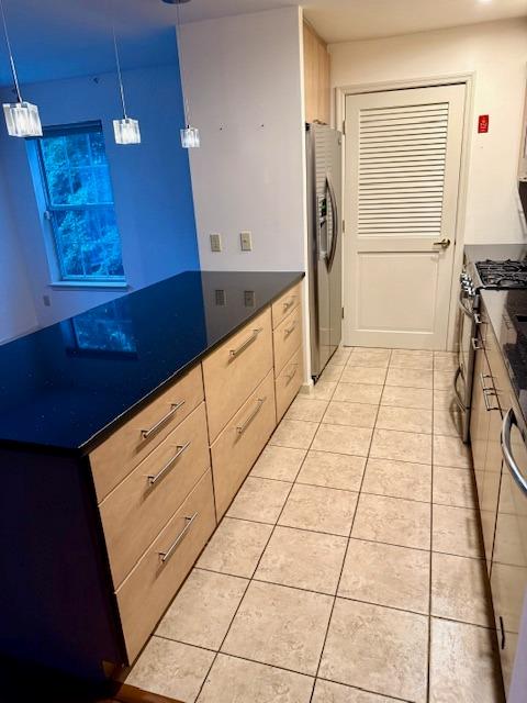 1010 Washington Grn Unit 1010, New Windsor, NY 1255312553 - kitchen with stainless steel appliances, light tile patterned floors, dark countertops, and hanging light fixtures