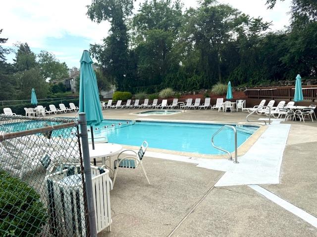 1010 Washington Grn Unit 1010, New Windsor, NY 1255312553 - community pool featuring a patio, a community hot tub, and view of scattered trees