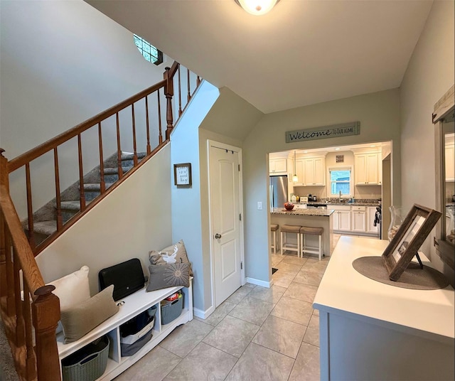 1 Roberta St, East Patchogue, NY 11772 - stairs featuring baseboards, tile patterned floors, and vaulted ceiling