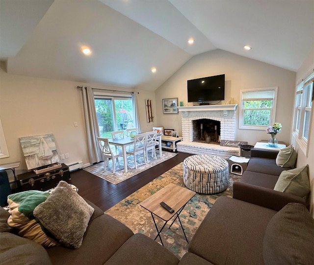 1 Roberta St, East Patchogue, NY 11772 - living area with dark wood finished floors, lofted ceiling, plenty of natural light, baseboard heating, and a brick fireplace