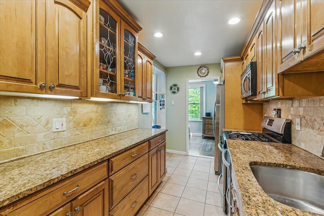 209-80 18th Ave Unit 4D, Bayside, NY 11360 - kitchen featuring stainless steel appliances, tasteful backsplash, light stone countertops, brown cabinets, and recessed lighting