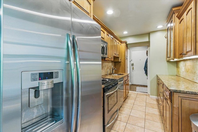 209-80 18th Ave Unit 4D, Bayside, NY 11360 - kitchen with stainless steel appliances, backsplash, light tile patterned flooring, recessed lighting, and brown cabinets