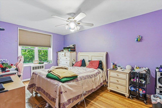 209-80 18th Ave Unit 4D, Bayside, NY 11360 - bedroom with radiator, light wood-style flooring, and ceiling fan
