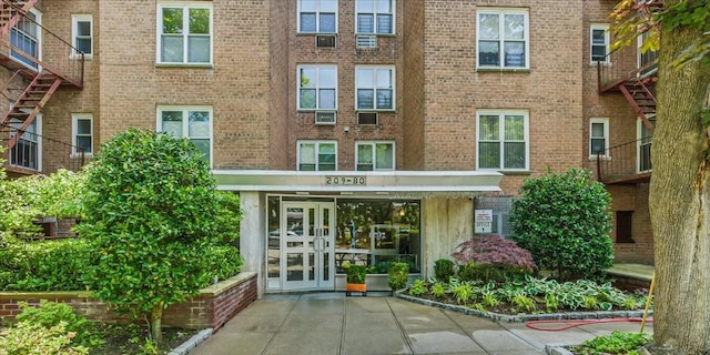 209-80 18th Ave Unit 4D, Bayside, NY 11360 - property entrance with french doors and brick siding