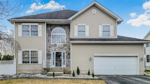 2717 Colonial Dr, New Windsor, NY 12553 - view of front of house with asphalt driveway, stone siding, and an attached garage