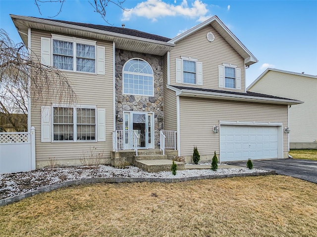 2717 Colonial Dr, New Windsor, NY 12553 - traditional-style home featuring asphalt driveway, an attached garage, a front yard, and stone siding