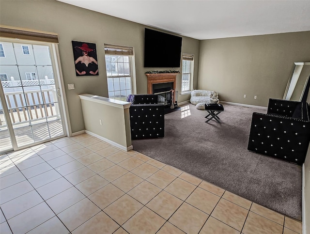 2717 Colonial Dr, New Windsor, NY 12553 - living room with a fireplace, light colored carpet, light tile patterned flooring, and baseboards