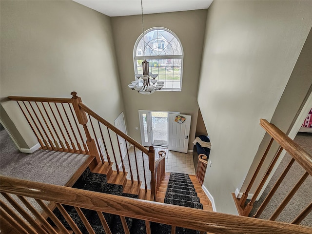 2717 Colonial Dr, New Windsor, NY 12553 - stairway with a chandelier, plenty of natural light, a towering ceiling, and baseboards