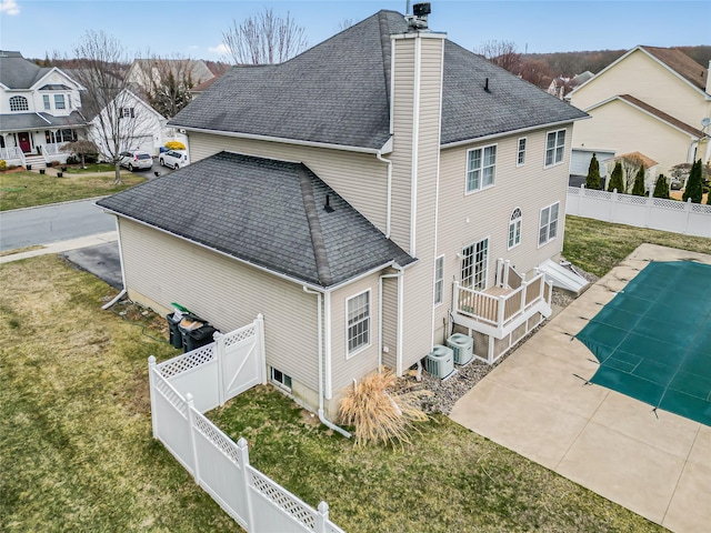 2717 Colonial Dr, New Windsor, NY 12553 - rear view of house featuring a chimney, a shingled roof, cooling unit, and a residential view