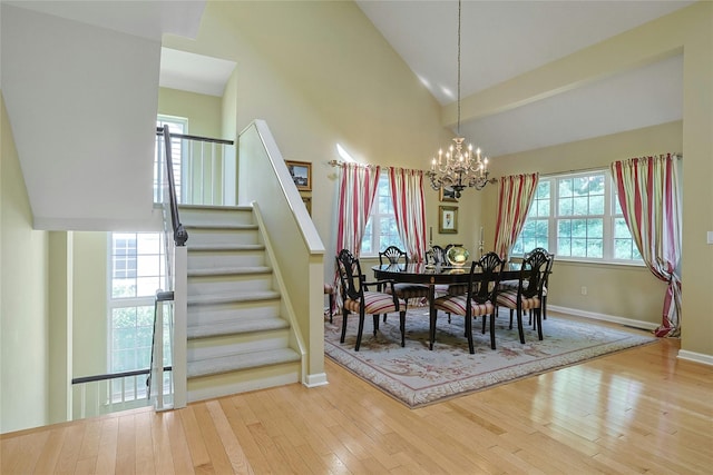 17 Deer Tree Ln, Briarcliff Manor, NY 10510 - dining area featuring a chandelier, stairway, hardwood / wood-style floors, baseboards, and high vaulted ceiling